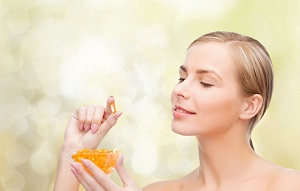 woman holding fish oil supplement